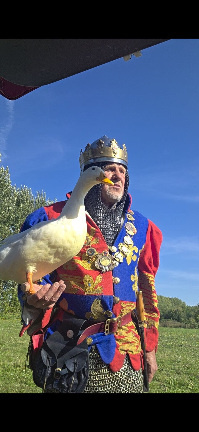 Mark in full medieval king costume with crown and chainmail, a white duck perched on his arm